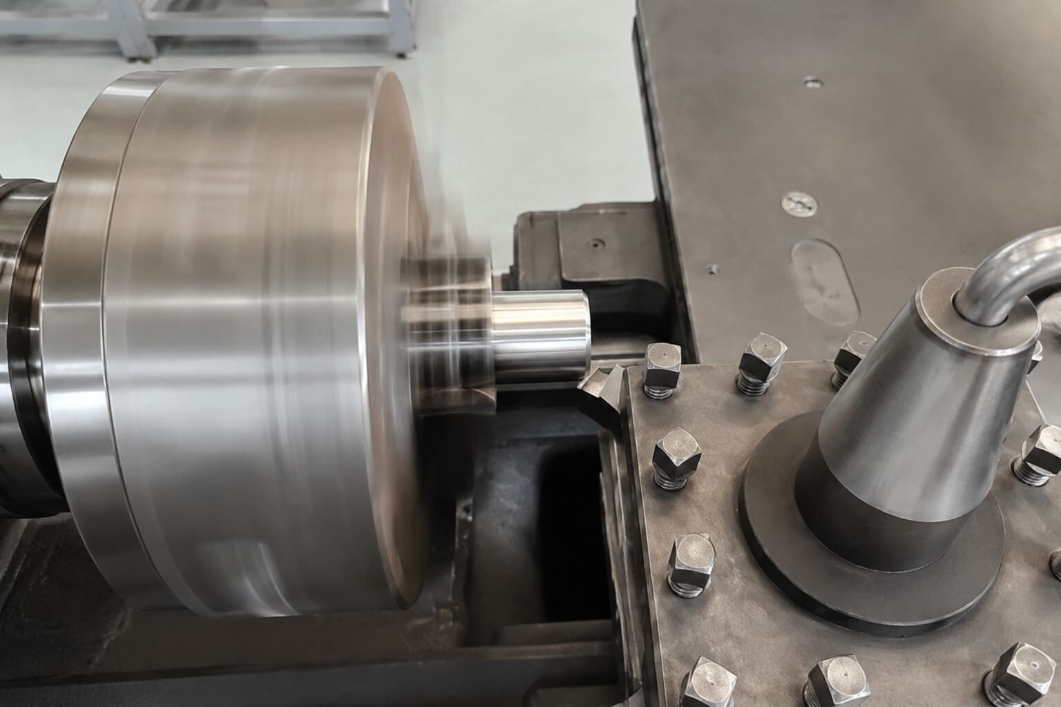 A metal component being turned on a lathe